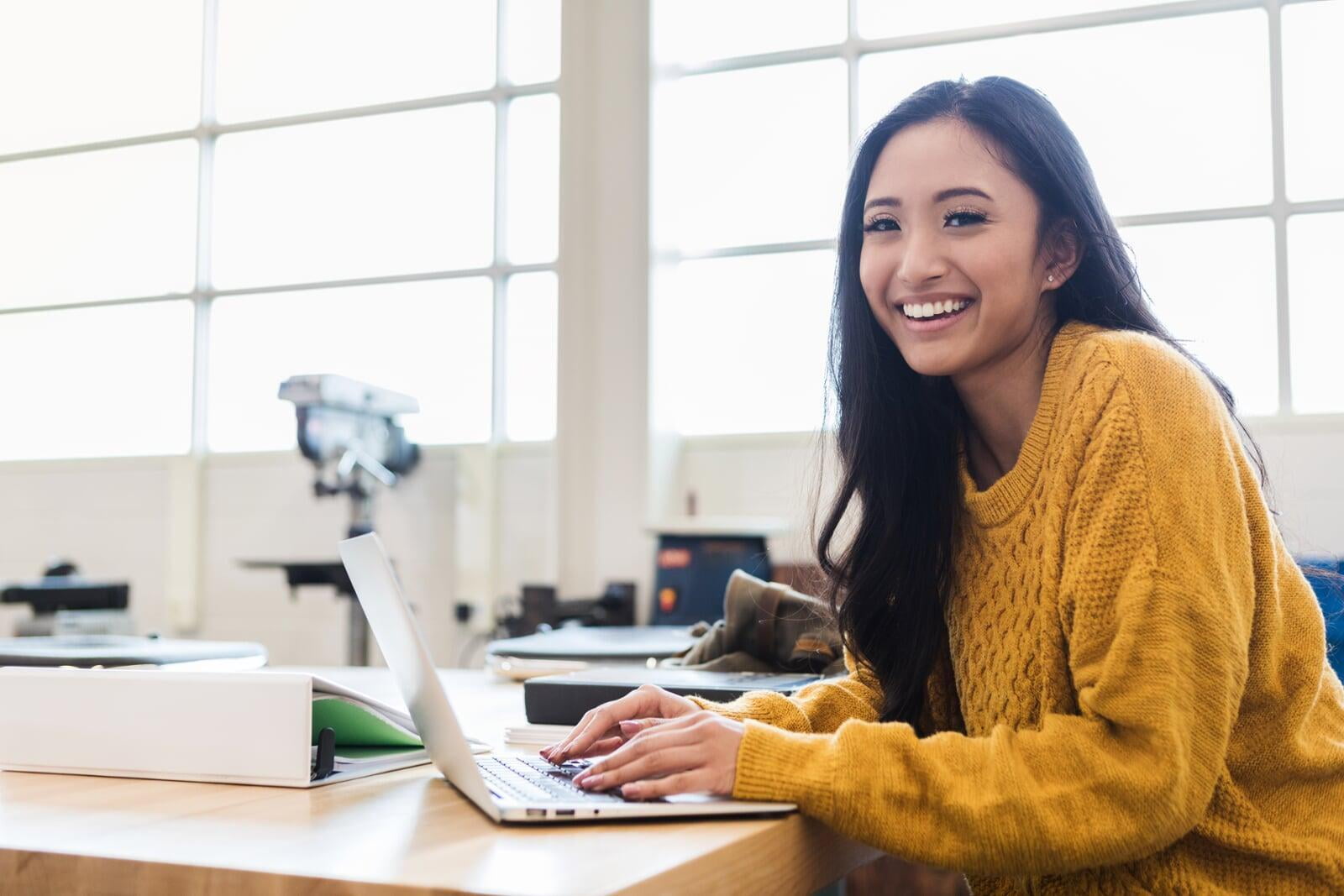 College aged female on laptop computer.