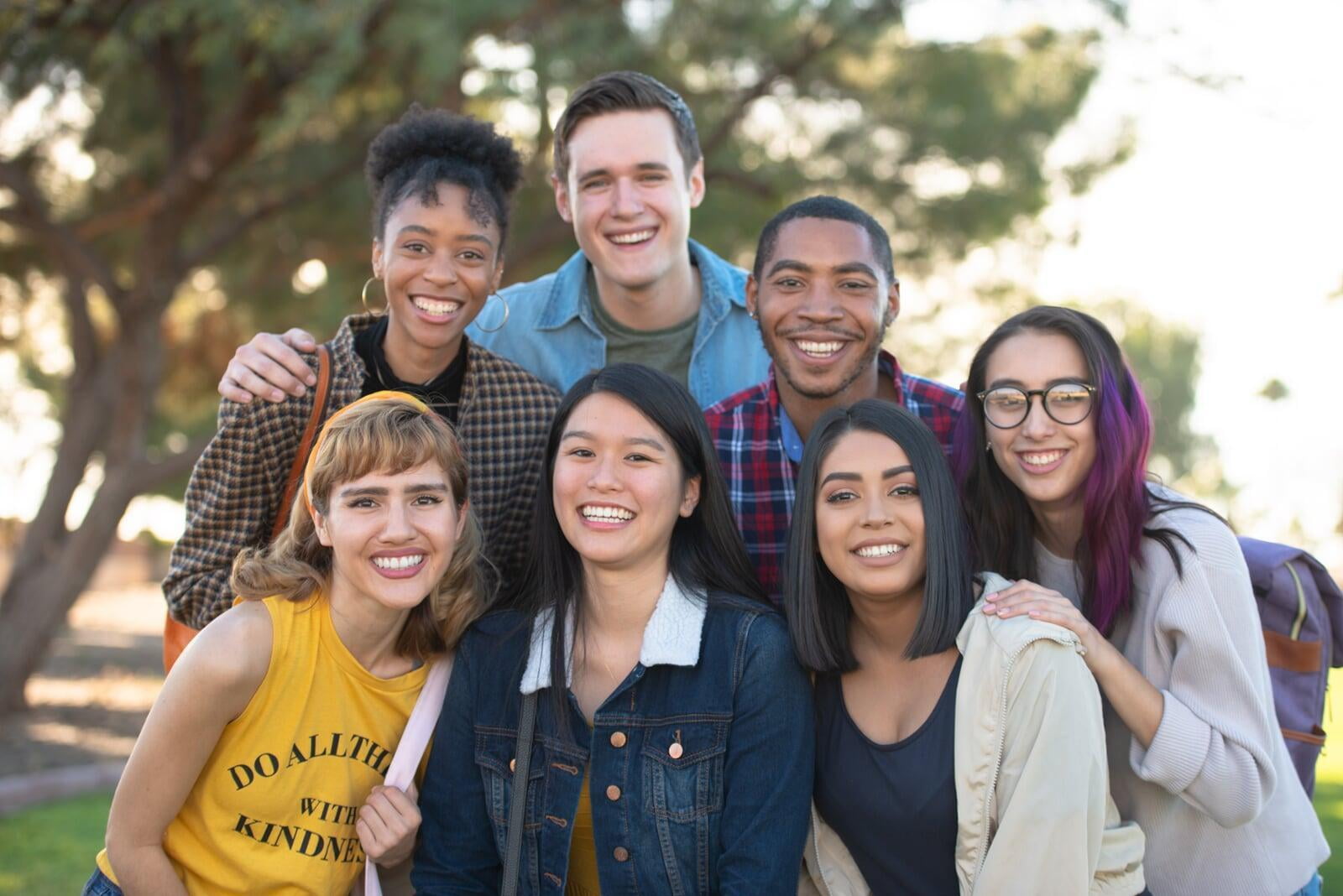 Group of seven students outside smiling. 